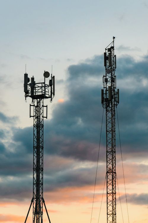 a-couple-of-cell-towers-sitting-next-to-each-other-bM95-JyNI3k.jpg