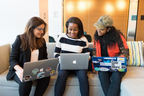 three-women-sitting-on-sofa-with-macbook-OW5KP_Pj85Q.jpg