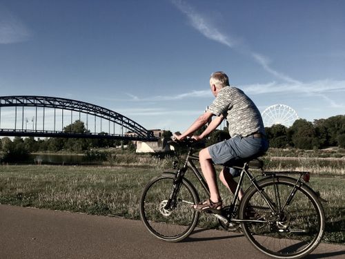 man-in-gray-and-white-striped-shirt-riding-black-bicycle-on-road-during-daytime-yIR4WyOa1D8.jpg