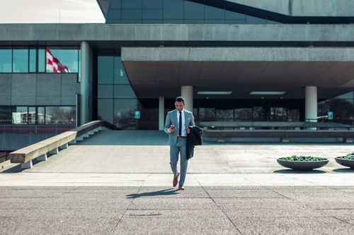 man-walking-while-holding-black-coat-oqnVnI5ixHg.jpg